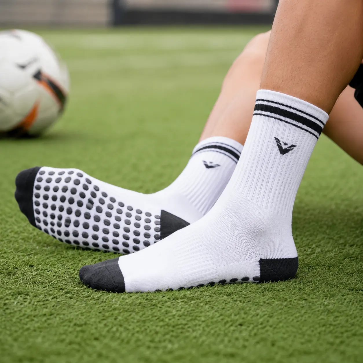 Football grip socks on a grass pitch